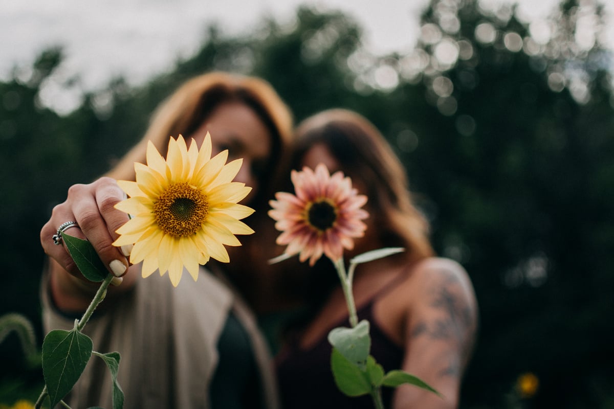 Two Women Holding Flowers